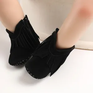 Close-up detail of black fringe baby walking boots featuring side zippers and non-slip soles