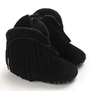 Detail of black baby fringe boots with soft non-slip soles and warm fleece lining.