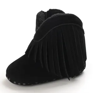 Detailed view of black baby girl boots featuring stylish tassel fringe and soft sole