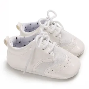 Classic white soft-soled baby walker shoes with brogue details and star pattern lining
