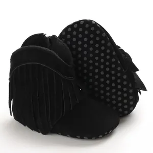 Detailed view of stylish black baby boots with fringe and anti-slip dotted sole