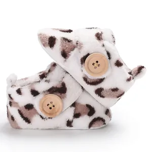 Soft leopard print faux fur baby booties with decorative wooden buttons