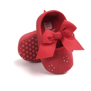 Adorable red embroidered baby princess shoes featuring large ribbon bows and soft soles