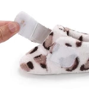 Close-up detail of the adjustable Velcro closure on leopard print baby plush booties
