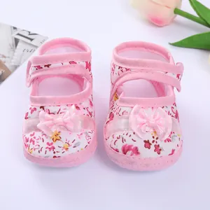 Detailed view of pink floral baby soft-sole walker shoes with bow decoration