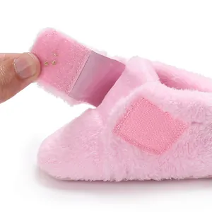 Detail view of soft pink fluffy baby walking shoe with a convenient velcro strap