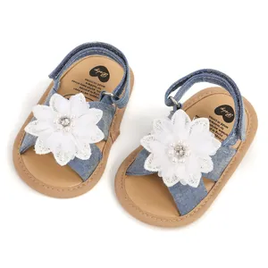 Vue détaillée de sandales en jean bleu pour bébé avec fleur en dentelle et semelle souple