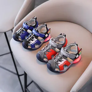 Close-up of children's sporty sandals with glowing LED soles in blue and red