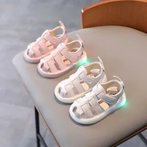 Pink and white toddler light-up hollowed-out sandals with colorful LED glow soles