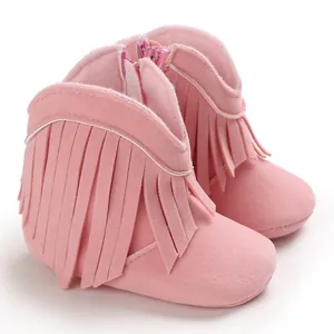 Side view of pink suede-like baby boots with fringe decoration and back zipper