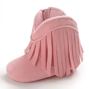 Detailed side profile of stylish pink suede baby boots with soft fringe decoration for girls
