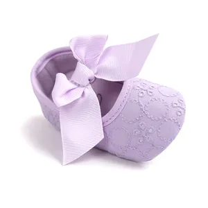 Close-up of a soft-soled purple baby princess shoe with floral embroidery and bow