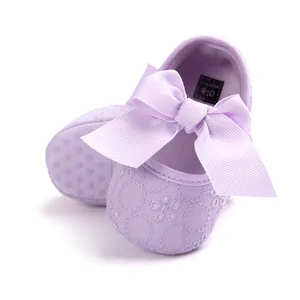 Close-up view of lilac baby princess walker shoes featuring large bow and embroidery