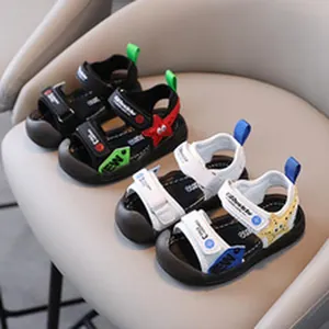 Close-up view of children's sporty sandals featuring starfish patches in black and white colors