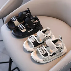 Detailed view of two pairs of children's sports sandals in black and white colors