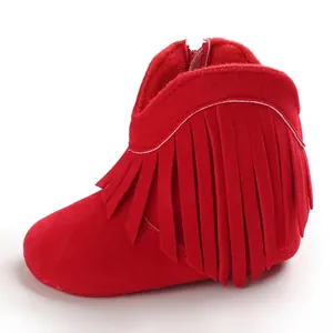 A detailed side view of stylish red infant fringe boots with soft sole for baby girls