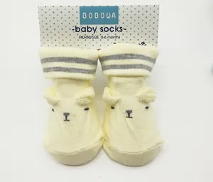 Yellow combed cotton baby socks with cute bear face design and 0-6 months size tag
