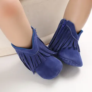 Detailed macro view of dark blue baby tassel boots featuring fringe and soft soles