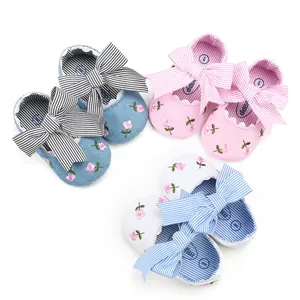 Floral embroidered baby princess shoes with striped bows in pink, white, and blue colors.
