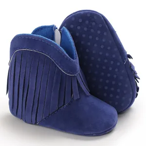 Detail showing navy blue suede-like baby boots with stylish side fringe accents.