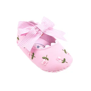 Pink baby girl princess shoes with floral embroidery and large striped bow detail