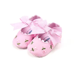 Pink floral baby girl princess shoes featuring a large striped bow and soft walking sole