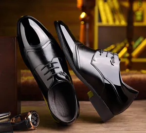 Detailed view of shiny black patent leather business dress shoes with hidden height increase.