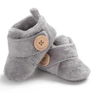 Cozy grey plush baby pre-walker shoes featuring a decorative wooden button accent