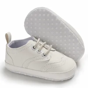 Detail van witte baby loopschoen met zachte zool en antislip noppen aan onderkant