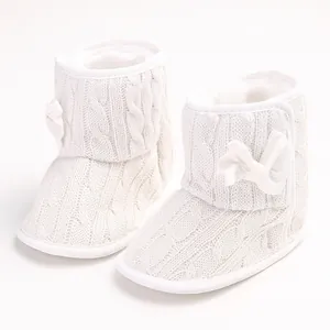 Detailansicht der weißen Strick-Babystiefel mit weicher Sohle und Schleife