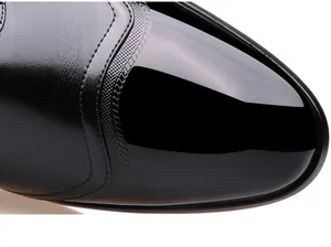 Close-up detail of men's business leather shoe toe showing glossy finish and stitching