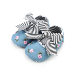 Detailed view of floral embroidery and striped bow on soft sole baby princess shoes