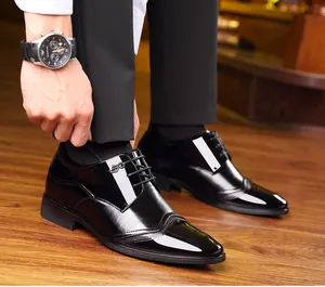 Detail view of glossy black men's business dress shoes with 8cm invisible height increase