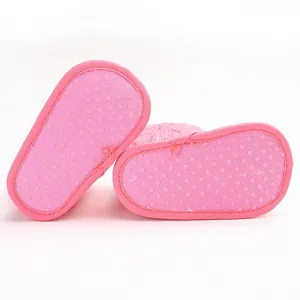 Detaillierte Ansicht der rosa Babyschuhsohlen mit einer rutschfesten Noppenstruktur.