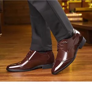Polished brown patent leather men's formal dress shoes with stylish lace-up detail
