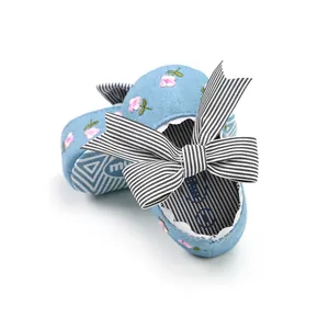Soft-soled blue floral baby walking shoes with a stylish black and white striped bow.