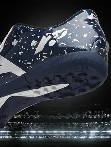 Macro view of blue kids' football shoe heel with silver star patterns and turf studs