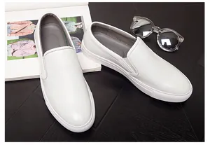 Detailed close-up view of white textured leather loafers for men, casual slip-on design