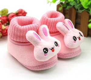 Close-up of pink baby pre-walker shoes with 3D cartoon bunny face and ribbed cuffs