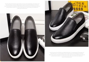 Detailed view of black lychee leather slip-on loafers with thick white soles.