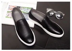 Macro view of premium black pebbled leather slip-on loafers with white platform soles