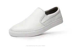 Close-up of white genuine leather slip-on loafers with textured grain and rubber sole.