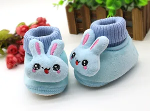 Detail view of light blue baby winter shoes with cute 3D bunny design and ribbed collar