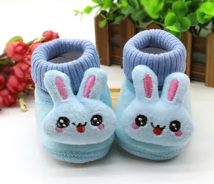 Close-up of light blue baby walker shoes with a 3D bunny face and ribbed collar.