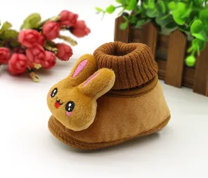 Close-up detail of plush baby winter shoe with cute 3D bunny face design