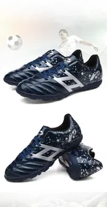 Professional children's navy blue turf soccer shoes with silver graphics and rubber studs