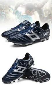 Professional navy blue kids soccer cleats with silver accents and spiked sole for grip