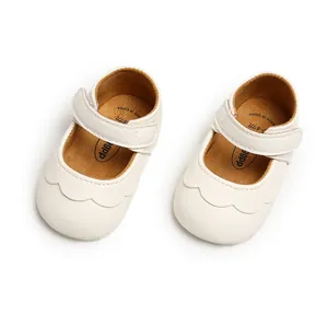 Close-up view of white PU leather infant Mary Jane shoes with scalloped edge detail