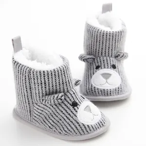 Detailed view of grey baby winter snow boots with cute bear face and warm plush lining