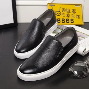 Premium black leather men's slip-on loafers featuring pebbled texture and white soles
